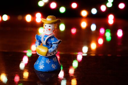 Clay figurine of woman in vintage dress with blur circular lightsの写真素材