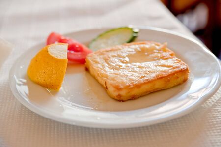 Cheese saganaki is famous Greek appetizer. It's made of fried cheese and is usually served with lemon.の写真素材