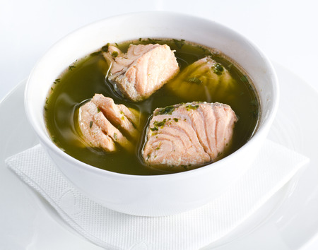 fish soup with salmon and leek on white surfaceの写真素材