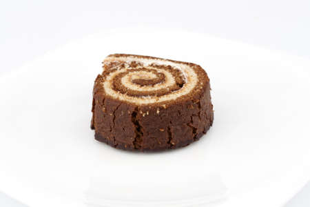 Chocolate Swiss roll closeup isolated on a white backgroundの写真素材