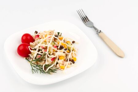 Crab salad on a plate with a fork lying nextの写真素材