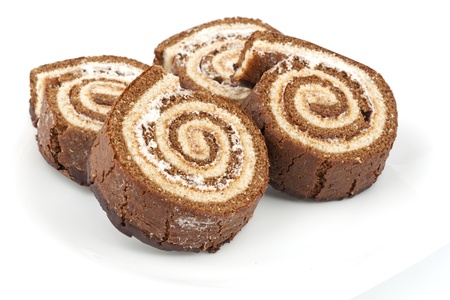 Four chocolate roll on a white plateの写真素材