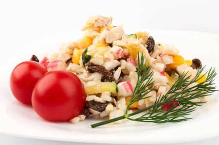 Crab salad, two tomatoes and a sprig of dill. On a white backgroundの写真素材