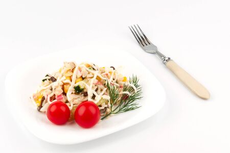 Crab salad on a plate with a fork lying nextの写真素材
