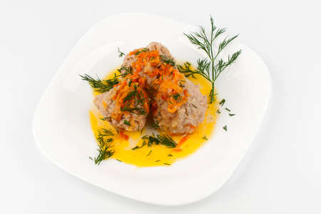 Meatballs on a white plate with a sprig of dillの写真素材
