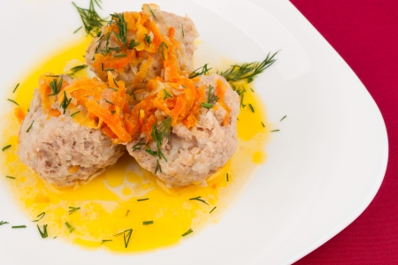 Three Meatballs on a white plate with a sprig of dillの写真素材