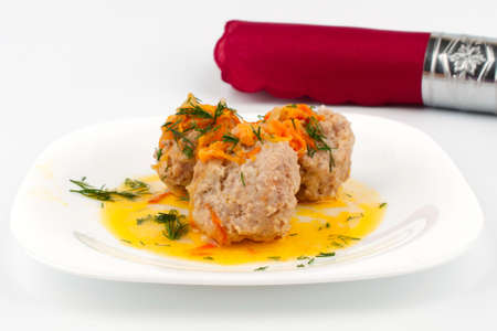 Red cloth napkin and a plate of meat balls and tomatoesの写真素材