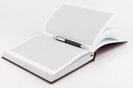 Black ballpoint pen lying in the center of diaryの写真素材