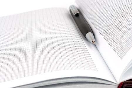 Notebook pages and a black ballpoint pen closeupの写真素材