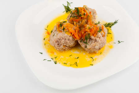 Three Meatballs on a white plate with a sprig of dillの写真素材