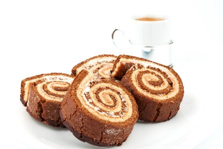 Several chocolate roll on a plate with a cup of coffeeの写真素材