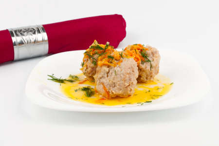 Red cloth napkin and a plate of meat balls and tomatoesの写真素材