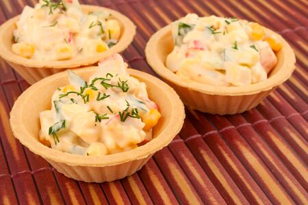 Tartlets with salad on a bamboo napkinの写真素材