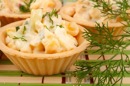 Tartlets with salad on a bamboo napkinの写真素材