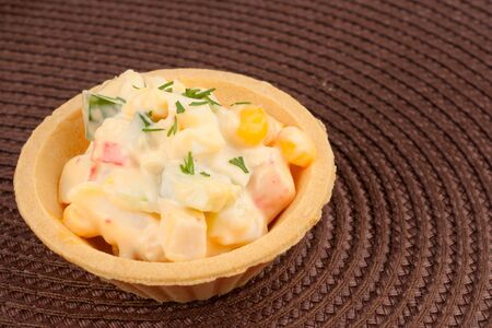 Tartlet with salad on brown napkinの写真素材