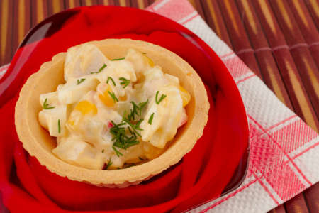 Tartlet with salad on a red plateの写真素材