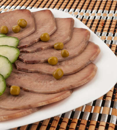 Slices of boiled beef tongue with green peasの写真素材