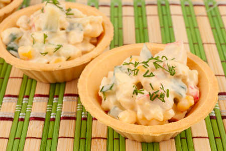 Tartlets with salad on a bamboo napkinの写真素材