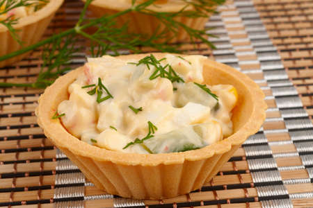 Tartlets with salad on a bamboo napkinの写真素材