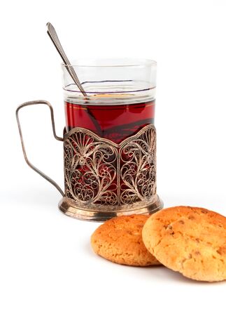 Glass cup of tea in the cup holderの写真素材