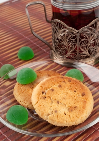 Two round biscuits with green jelly sweetsの写真素材