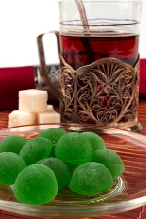 Green jelly sweets on a glass saucerの写真素材