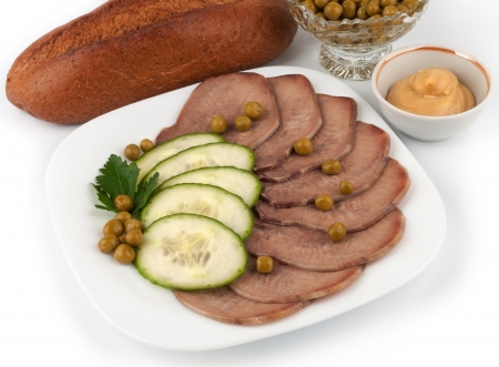 Slices of boiled beef tongue with green peasの写真素材