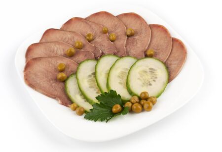 Slices of boiled beef tongue with green peasの写真素材