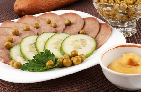 Slices of boiled beef tongue with green peasの写真素材