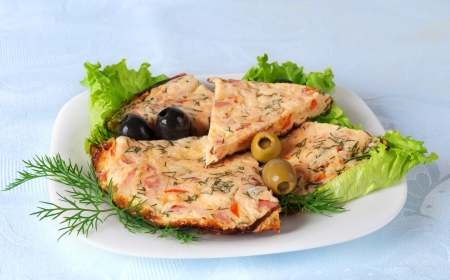 Slices of omelette on a plate  Against the background of a blue tableclothの写真素材