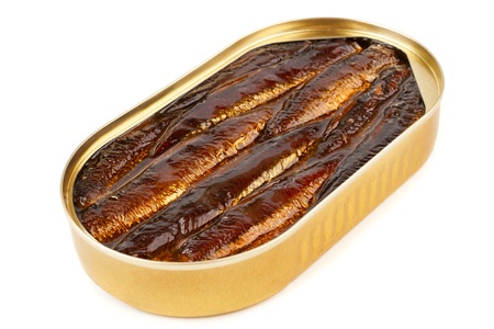 An open oval can of sprats in oil on a white backgroungの写真素材
