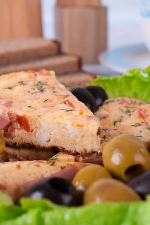 Slices of omelette on a plate  Against the background of a blue tableclothの写真素材