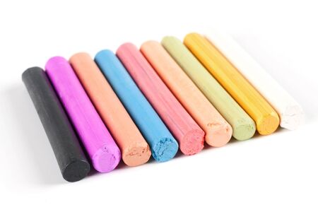 chalks in a variety of colors arranged on a white backgroundの写真素材