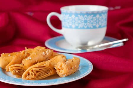 Biscuit rolls sprinkled with sesame seeds on a blue dish  On the red tablecloth の写真素材
