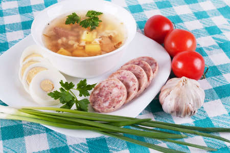 Soup and a variety of vegetables on colored tableclothsの写真素材