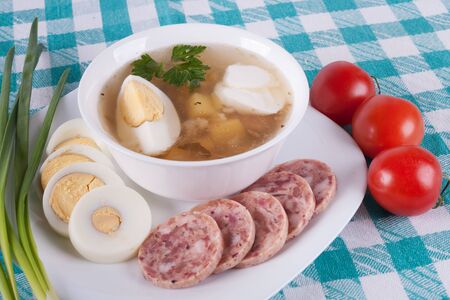 Soup with egg and sour cream  Garnished with greens and vegetables の写真素材