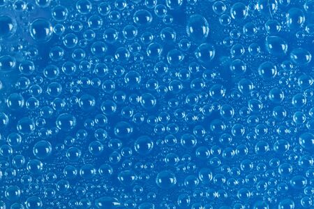 Water drops on blue matt glass close upの写真素材