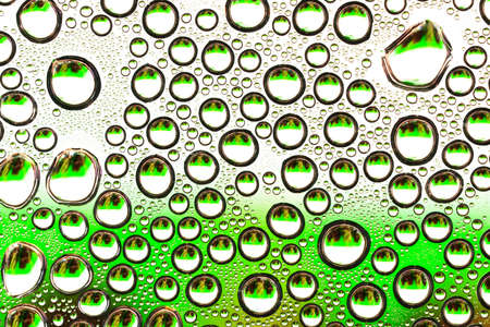 Water drops on green transparent glass close upの写真素材