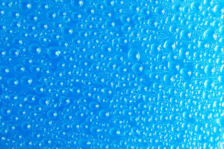 Water drops on blue matt glass close upの写真素材