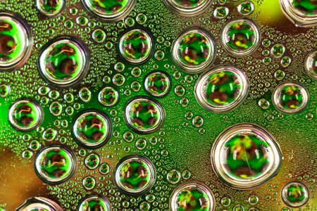 Water drops on green transparent glass close upの写真素材