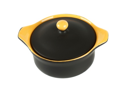 Black and yellow ceramic pot for baking on a white backgroundの写真素材