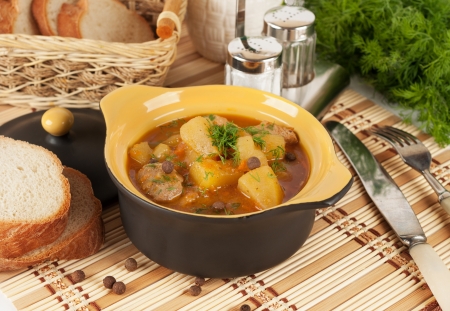 Stewed potatoes with meat in a ceramic pot の写真素材