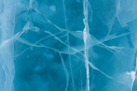 Beautiful ice of river with abstract cracks
