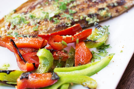 Grilled vegetables and fish fillets doradoの写真素材
