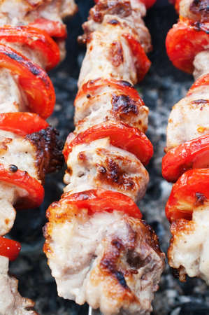 Pork kebab with tomatoes roasted on the grill の写真素材