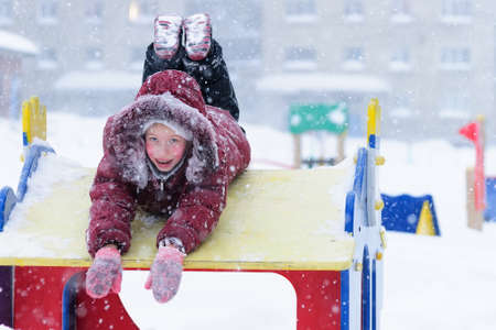 Girl walking on playground in winter の写真素材