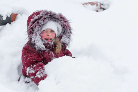 Girl playing with snow in the snow 