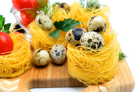 Italian pasta nests with cherry tomatoes and quail eggs の写真素材