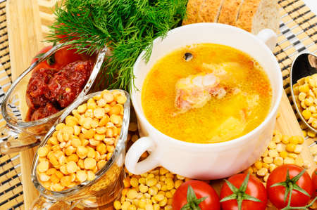 Pea soup with bacon  In white ceramic cup  Decorated with dill and cherry tomatoes の写真素材