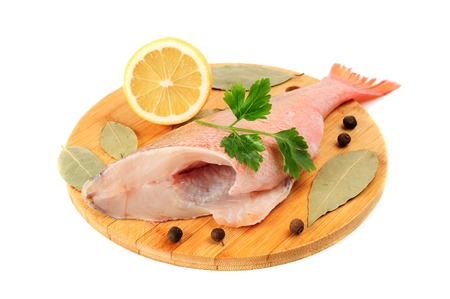 The split sea bass on a round cutting board 